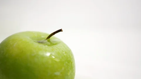 Green apple closeup cropped, splashed with drops of water Stock Footage 99262543