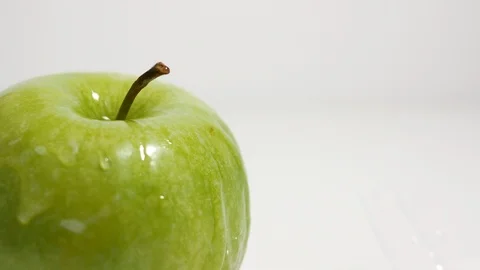 Green apple closeup cropped, splashed with drops of water Stock Footage 99263070
