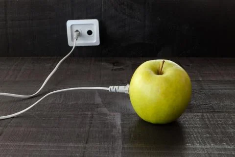Green apple connected to an ethernet cable Stock Photos