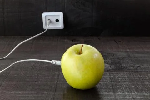 Green apple connected to an ethernet cable Stock Photos