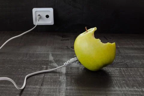 Green apple connected to an ethernet cable Stock Photos