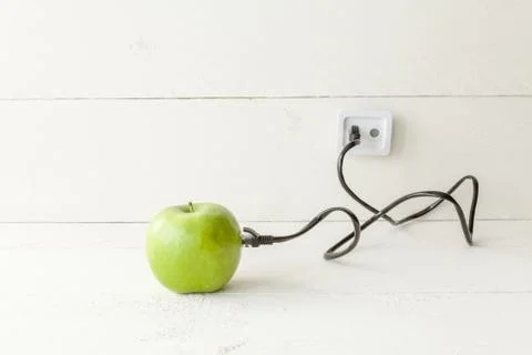 Green apple connected to an ethernet cable Stock Photos