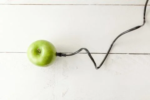 Green apple connected to an ethernet cable Stock Photos