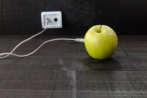 Green apple connected to an ethernet cable Stock Photos