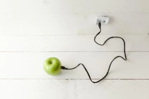 Green apple connected to an ethernet cable Stock Photos