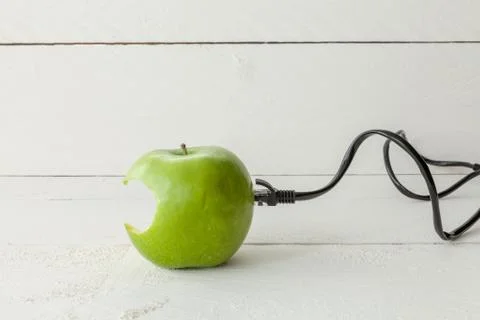 Green apple connected to an ethernet cable Stock Photos