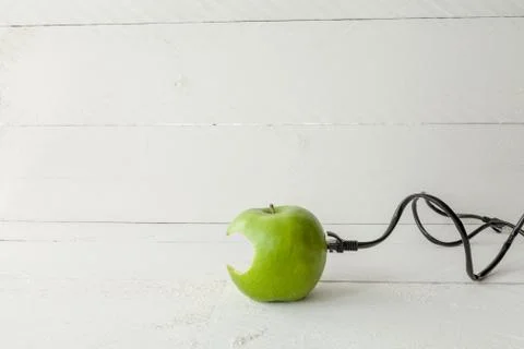 Green apple connected to an ethernet cable Stock Photos