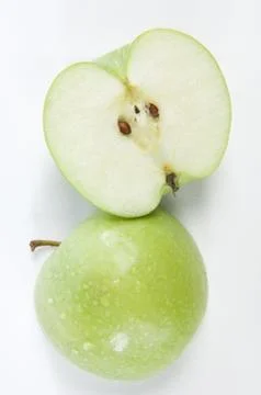 Green apple cut in half Stock Photos