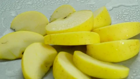 Green apple cut in rotation with water drops Stock Footage 234899720