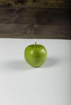A green apple on dark background Stock Photos