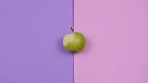 Green apple eating process stop motion animation isolated on two colored Stock Footage 128116987