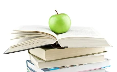 Green apple on the expanded textbook Stock Photos