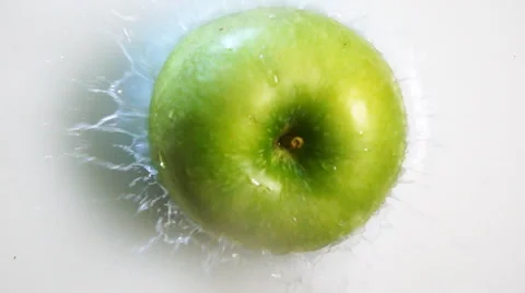 Green apple fall into the milk Stock Footage 62863568