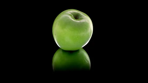 Green apple. Looping. Black background. Stock Footage 89311163