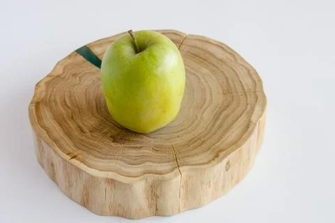 Green apple on the oak stand Stock Photos