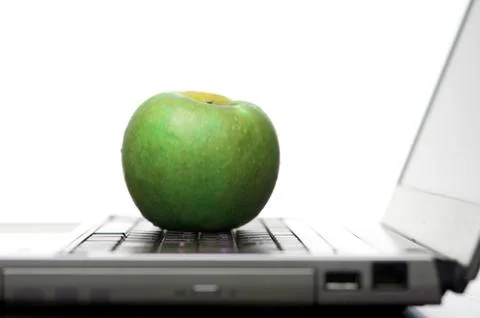Green apple on an open laptop computer Stock Photos
