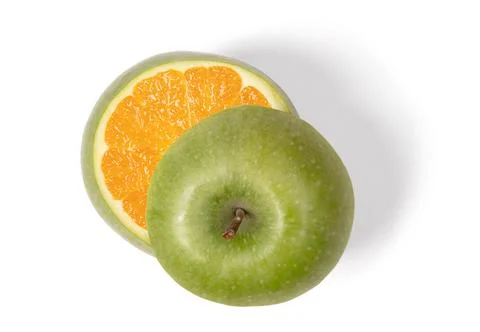 Green apple with orange inside Stock Photos