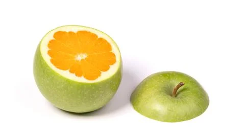 Green apple with orange inside Stock Photos