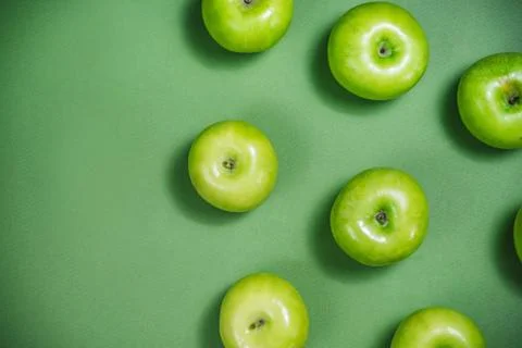 Green apple pattern on the green background. Stock Photos