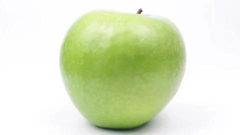 Green apple rotating on white background Stock Footage 233482863
