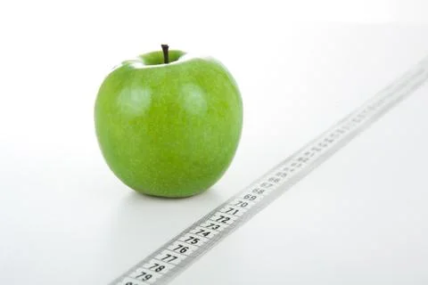 Green apple with a ruler Stock-Fotos