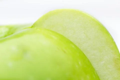 Green apple slice close up isolated on white Stock Photos
