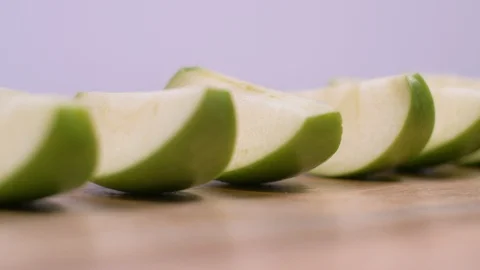 Green Apple Slices Rotating on White Background. Fresh, Produce Stock-Footage 128334486