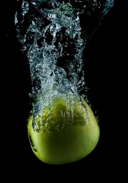 Green apple splashing. Stock Photos