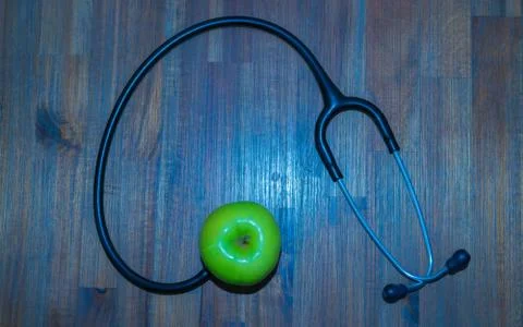 Green apple, stethoscope Stock Photos