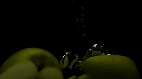 Green Apple in super slow motion falling in water on black background Stock Footage 80597809