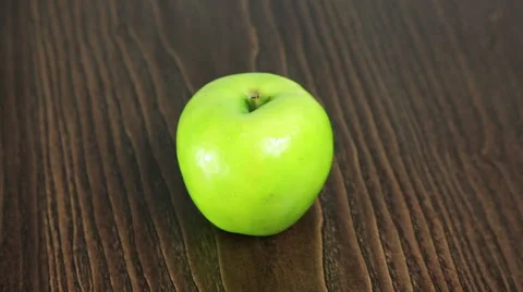 Green apple on the table rotates Stock Footage 61438536