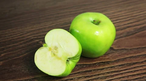 Green apple on the table rotates Stock Footage 61438574