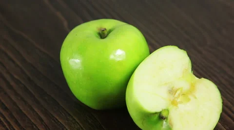 Green apple on the table rotates Stock Footage 61438850