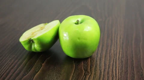 Green apple on the table rotates Stock Footage 61438972