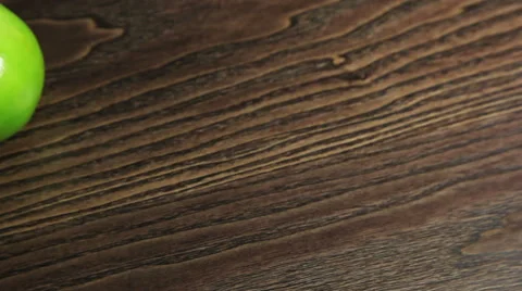Green apple on the table rotates Stock Footage 61439088