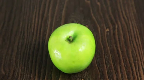 Green apple on the table rotates Stock Footage 61439220