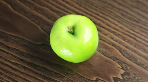 Green apple on the table rotates Stock Footage 61439397