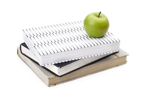 Green apple on top of a stack of books Stock Photos