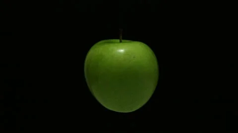 Green apple turning on black Stock Footage 67720200