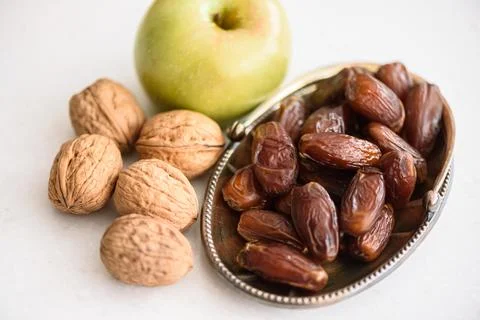 Green apple, walnuts and date fruits, Ingredients for the preparation of the Stock Photos
