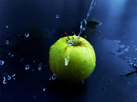 Green apple in the water Stock Photos