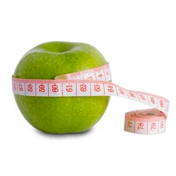 A green apple on a white background with a centimeter, shows the size of an Stock Photos