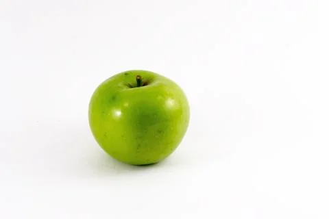 A green apple on a white background Stock Photos