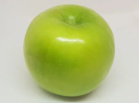 A green apple on a white background Stock Photos