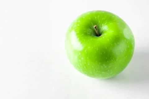 Green apple on a white background.  Stock Photos