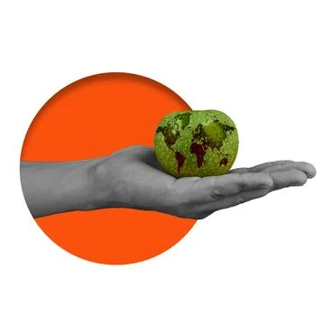 Green apple with world map design held in hand above orange circle background Stock Photos