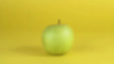 Green Apple on Yellow Background Stock Footage 57833137