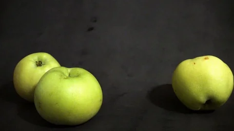 Green apples on a black background. fruit on black background. scattered apples. Stock Footage 99400922
