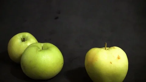 Green apples on a black background. fruit on black background. scattered apples. Stock Footage 99400925