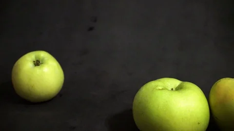 Green apples on a black background. fruit on black background. scattered apples. Stock Footage 99400931